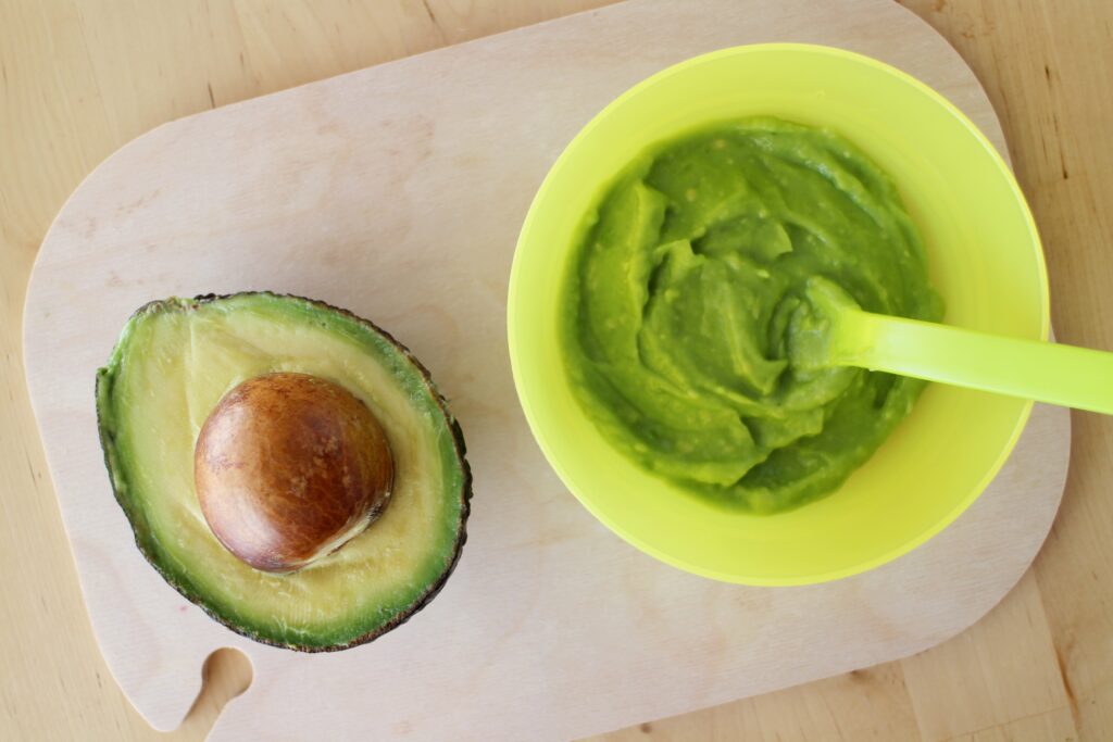 Avocado and Baby organic food avocado puree on a mat